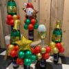 tafeldecoratie bollenstuk kerst champagne fles glas in de kleuren rood groen goud